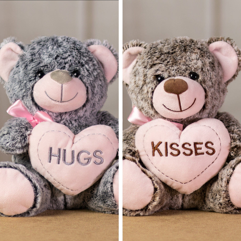 A gray and brown bear that are 9 inches tall while sitting holding pink hearts