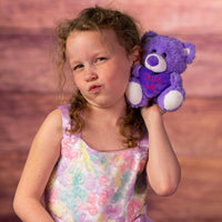 girl holding 5.5 in purple stuffed conversation heart bears